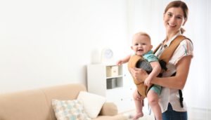 Woman,With,Her,Son,In,Baby,Carrier,At,Home.,Space